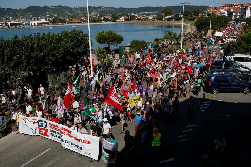  A group of activists march ahead of the start of the G7 summit