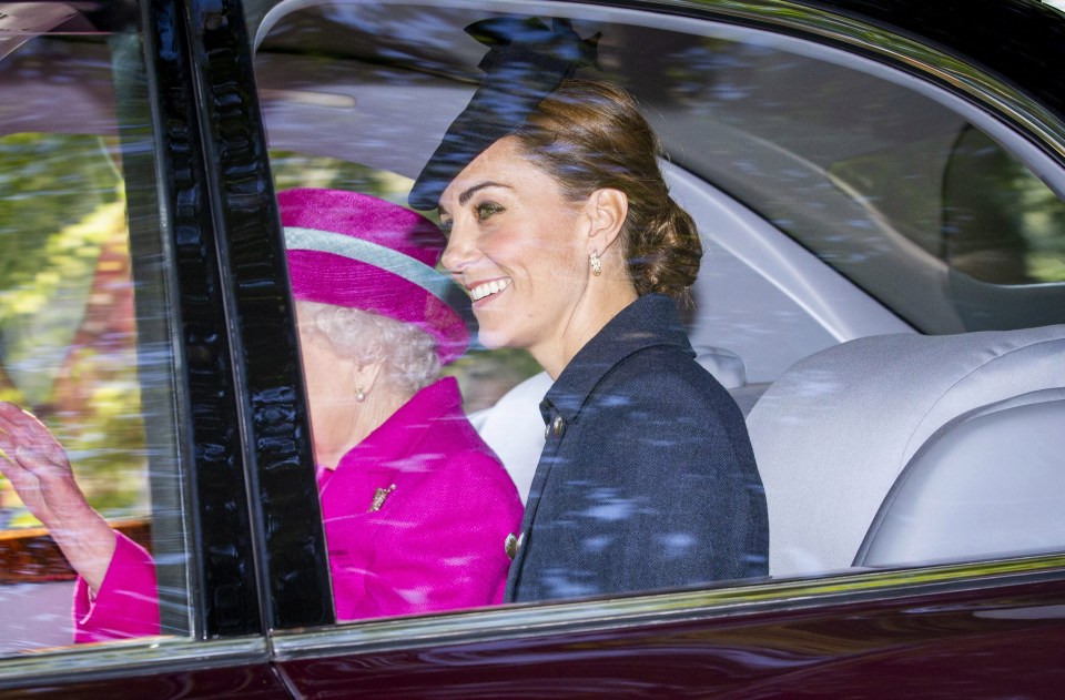 She ensured she didn’t over-shadow the Queen’s pink outfit by wearing an understated navy coat