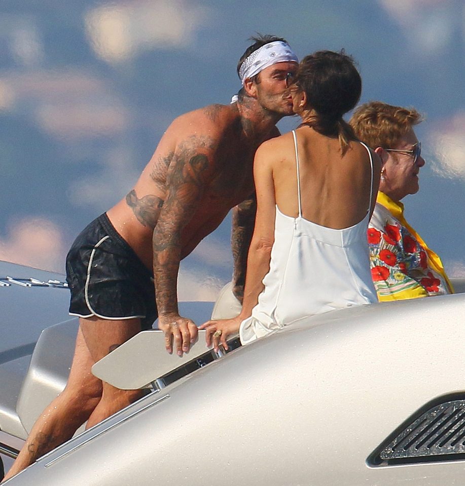  David kissed Victoria with Elton behind them on their European holiday