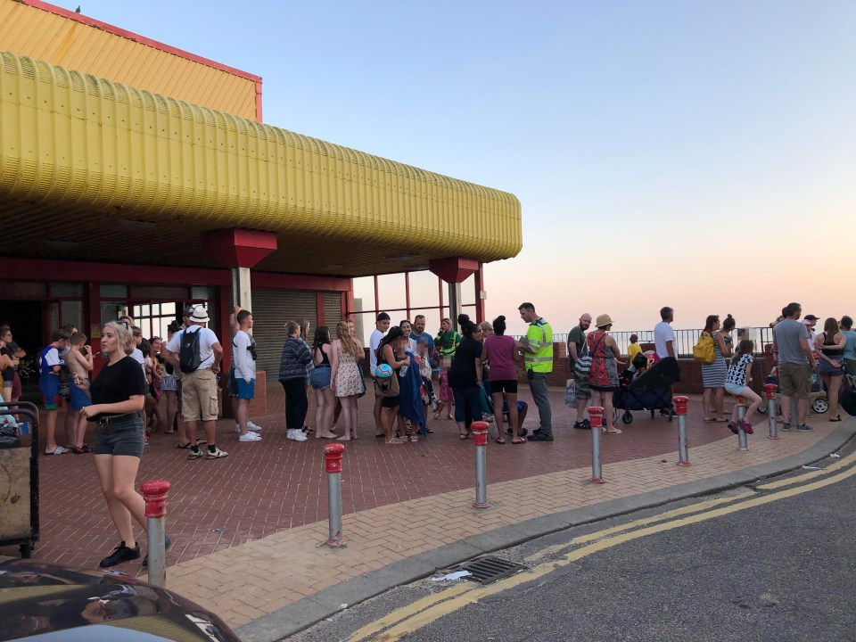  Paramedics speaking with beach-goers by the seafront after the worrying incidents on Saturday