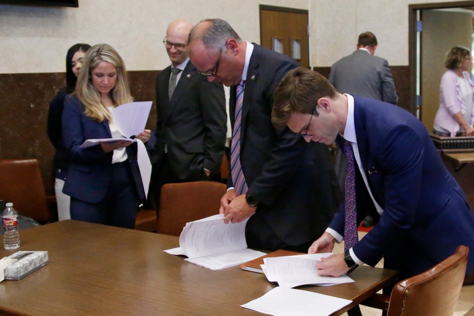  Oklahoma state attorneys look at documents during the landmark ruling on Monday