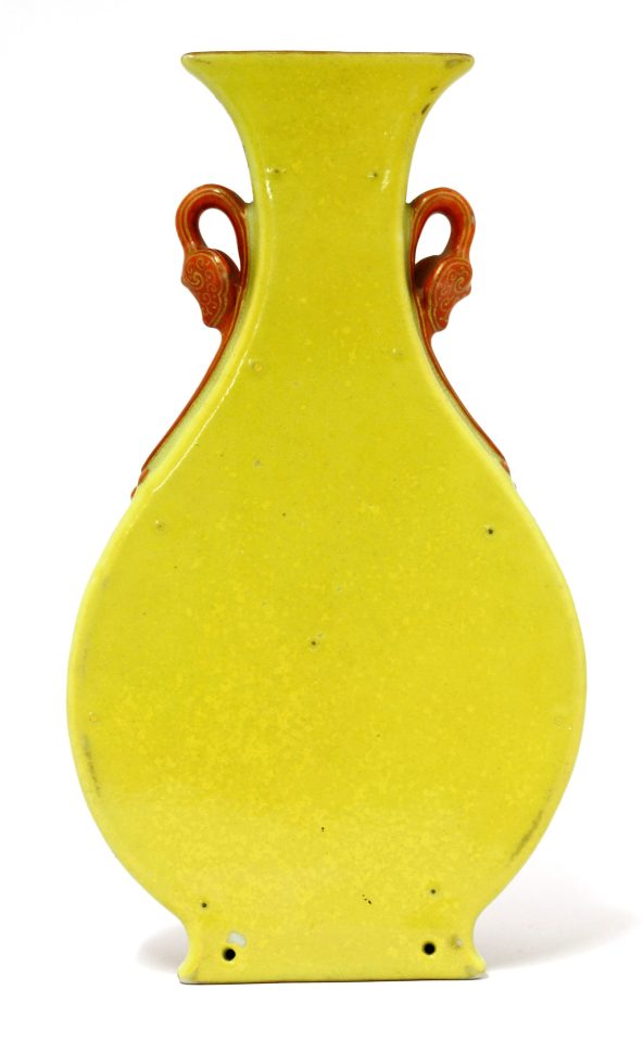  The small pear-shaped urn has a yellow back while the front is decorated with a floral pattern