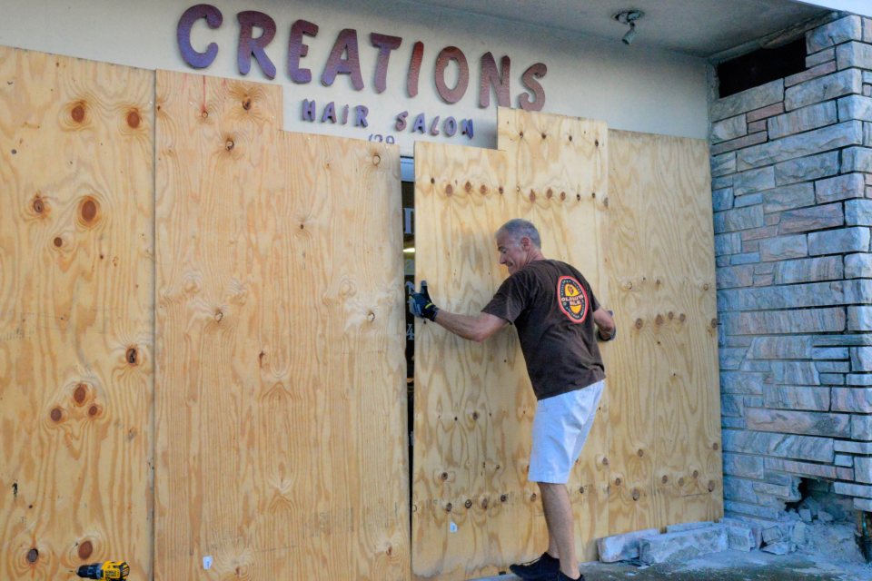  A local boards up his business in Melbourne Beach, Florida