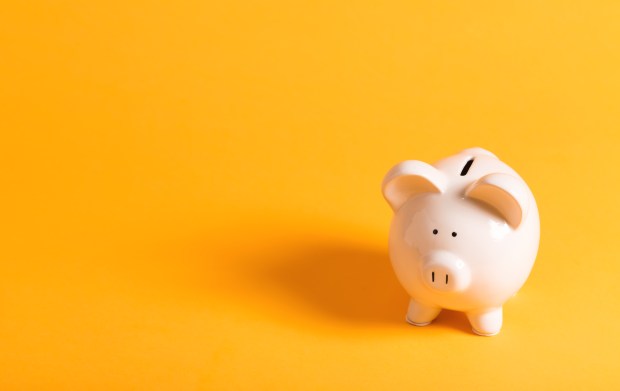 Piggy bank on yellow background