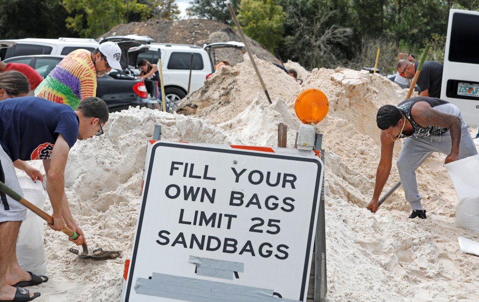 Residents in Kissimmee fill up sandbags to protect their homes from flooding ahead of Hurricane Dorian making landfall