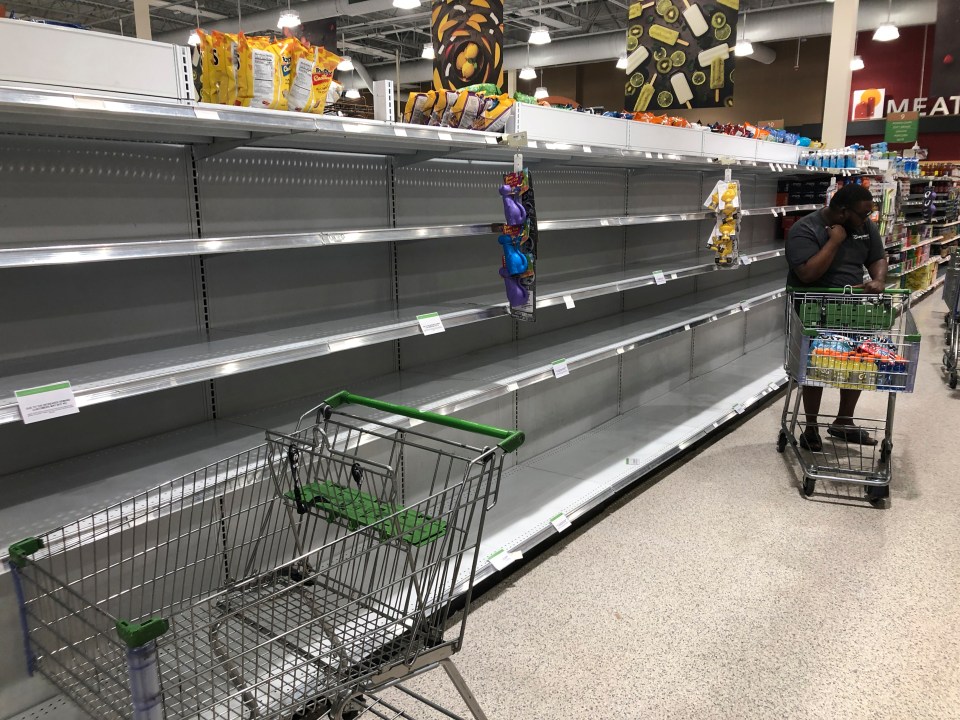 Shelves that used to carry cases of water have now been emptied at this supermarket in North Miami 