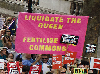  Stop The Coup marchers hold a sign that reads: 'Liquidate the Queen, fertilise the Commons'