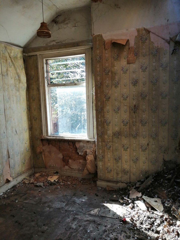  The dated and peeling wallpaper shows signs of serious damp conditions