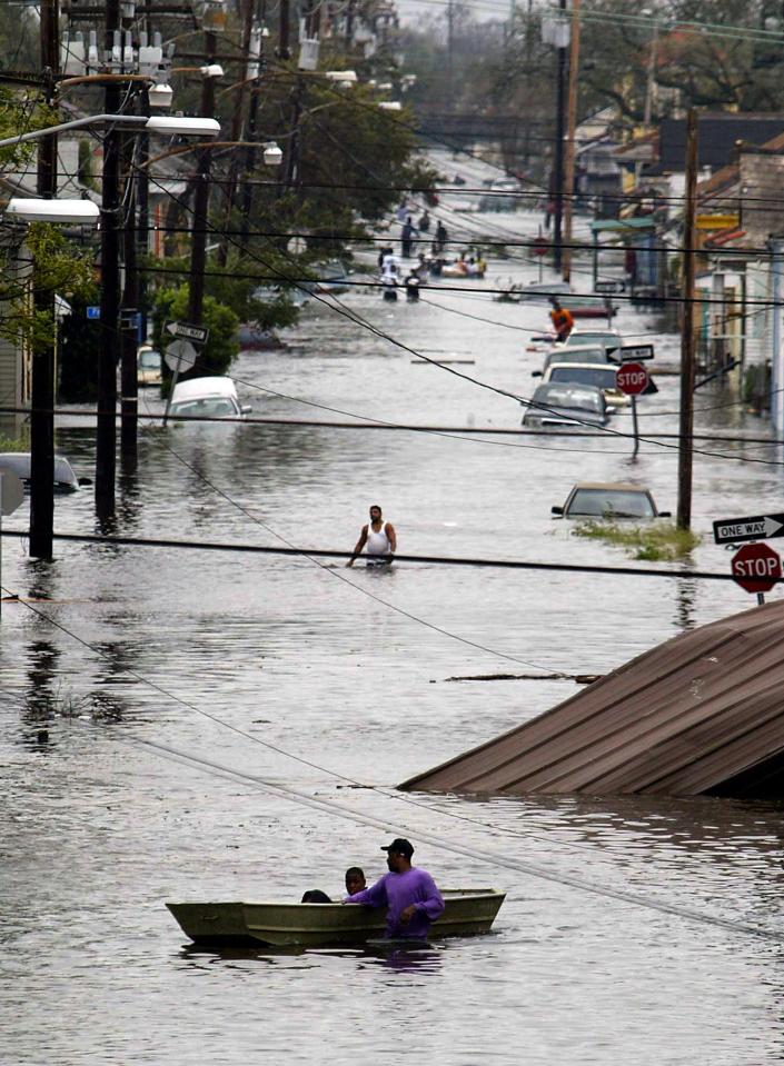  Residents wade through a flooded street in New Orleans after hurricane Katrina made landfall