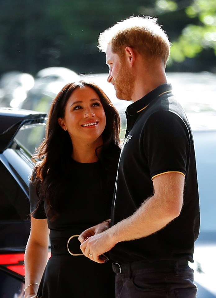  Meghan with Harry at a baseball game in London in June