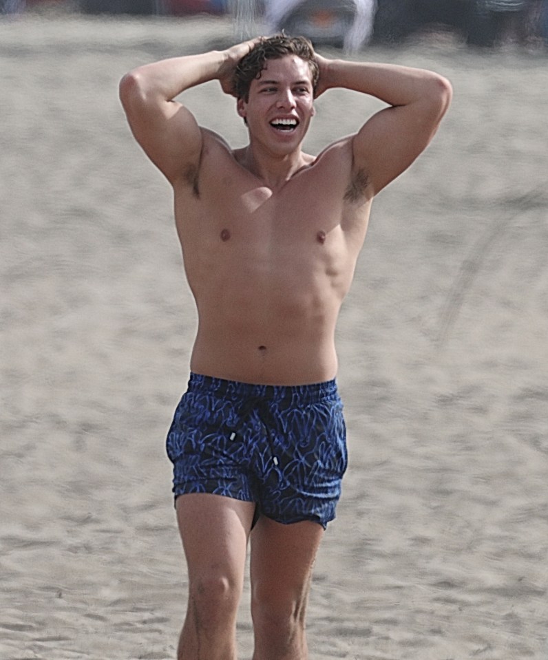 Joseph Baena flexed his muscles while on a California beach