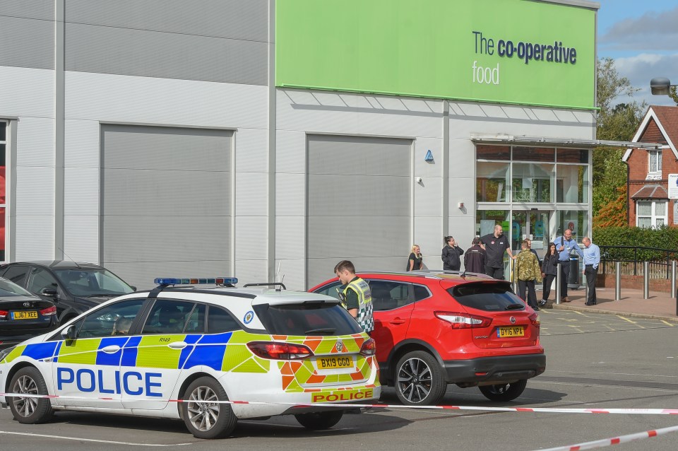  Cops at the scene of a suspected acid attack at a Co-op in Birmingham last week - four adults and two kids were injured when staff tried to stop a pair of thieves