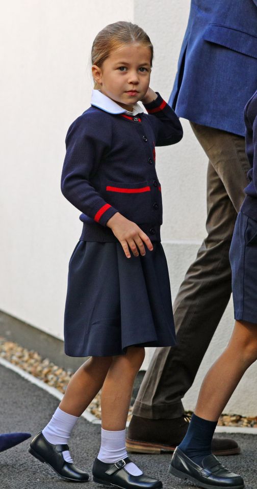  The young royal looked sweet in the trademark navy blue uniform