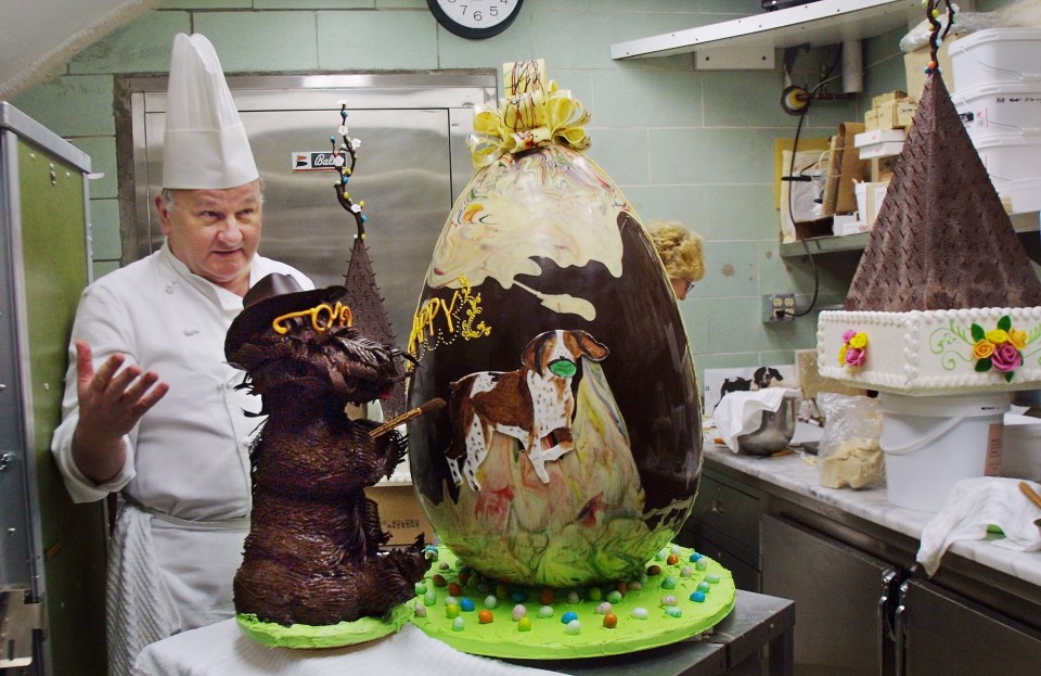  Pastry chef Roland Mesnier stands in the Chocolate Shop in March 2002 beside his impressive creation - a 40lb chocolate Easter egg, decorated with then-First Family dogs Barney and Spot