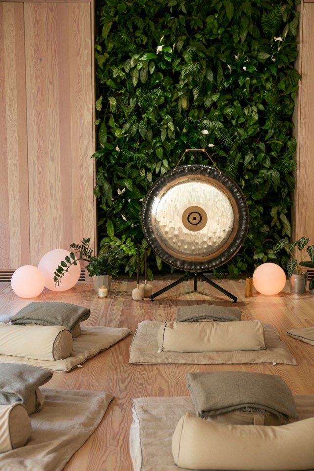  Visitors lie down on a cushion stuffed with buckwheat and under a grey blanket