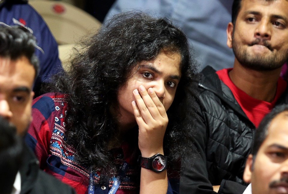  Onlookers at the Indian Space Research Organization headquarters in Bangalore react as contact with the lunar lander is lost