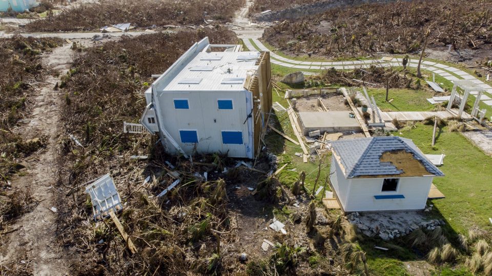  A house lying on its side having been ripped from the ground on Elbow Key Island