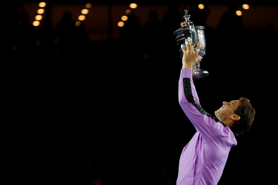  Rafa Nadal holds his trophy aloft after closing in on Roger Federer's haul