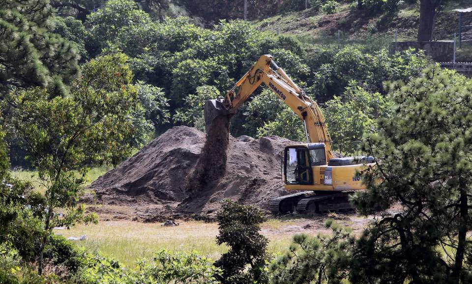  A mass grave being excavated in September as 50 more bodies have been found in a grave close by