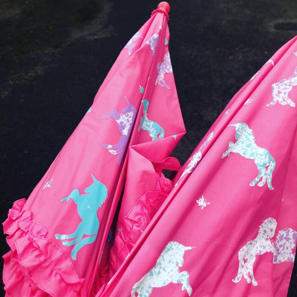 The brollies are covered in purple and blue unicorns which turn white when wet