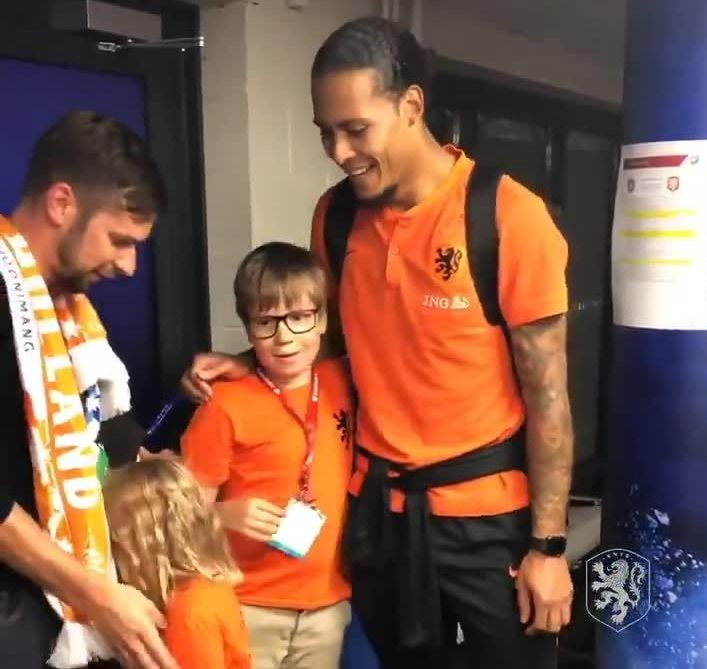 Liverpool and Holland superstar Virgil Van Dijk smiles as he gets different treatment from two young fans - with the girl too shy to turn round