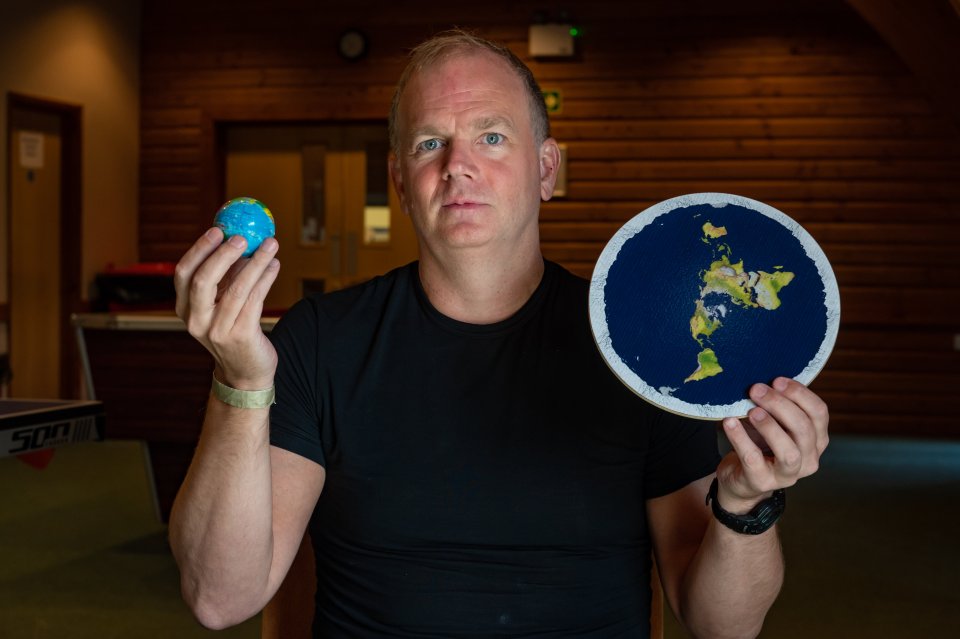  Blogger Mark Sargent, 51, holds a flat Earth disc and a globe to make his point