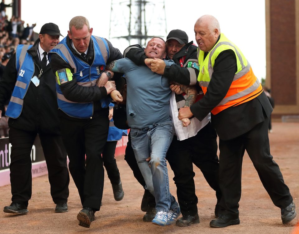  One fan was dragged away by security in a headlock amidst the melee