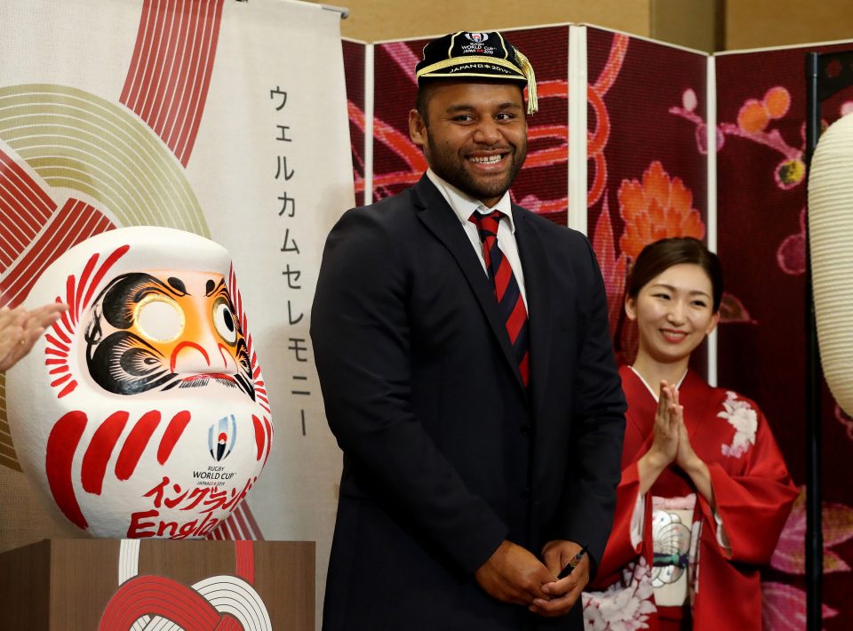  Vunipola shares a cheesy grin after painting the eye of the doll