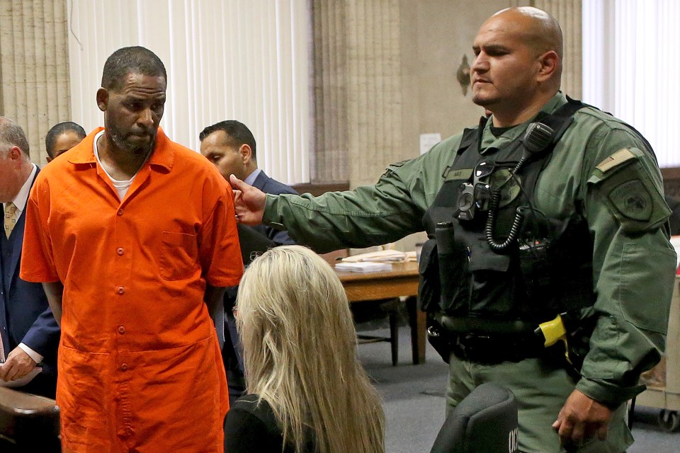  R Kelly, pictured last month, is led from a courtroom in Chicago. He is behind bars as he awaits trial