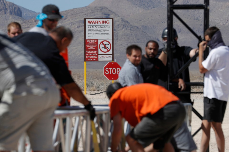  Workers erect a stage near a replica Area 51 gate sign at the Alien Research Center in Hiko, Nevada