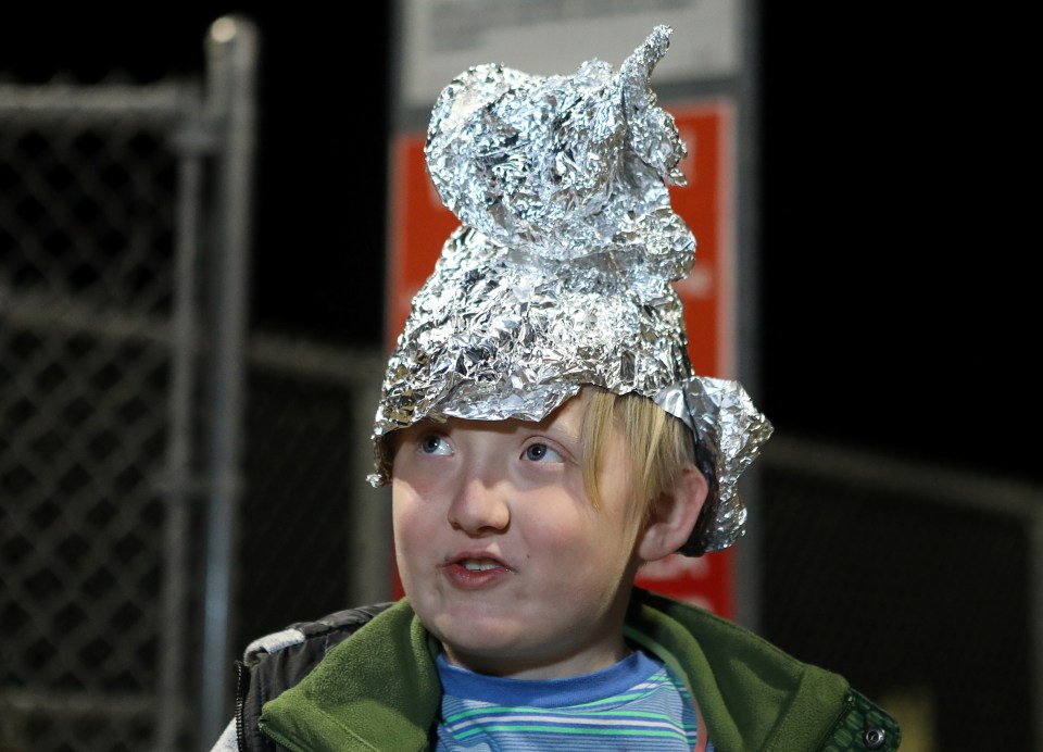  A boy wears a tinfoil hat at the gates of Area 51