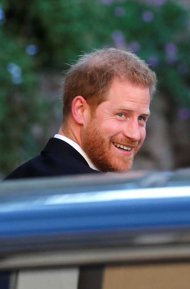 Prince Harry shot cameras a cheeky grin as he arrived at the wedding