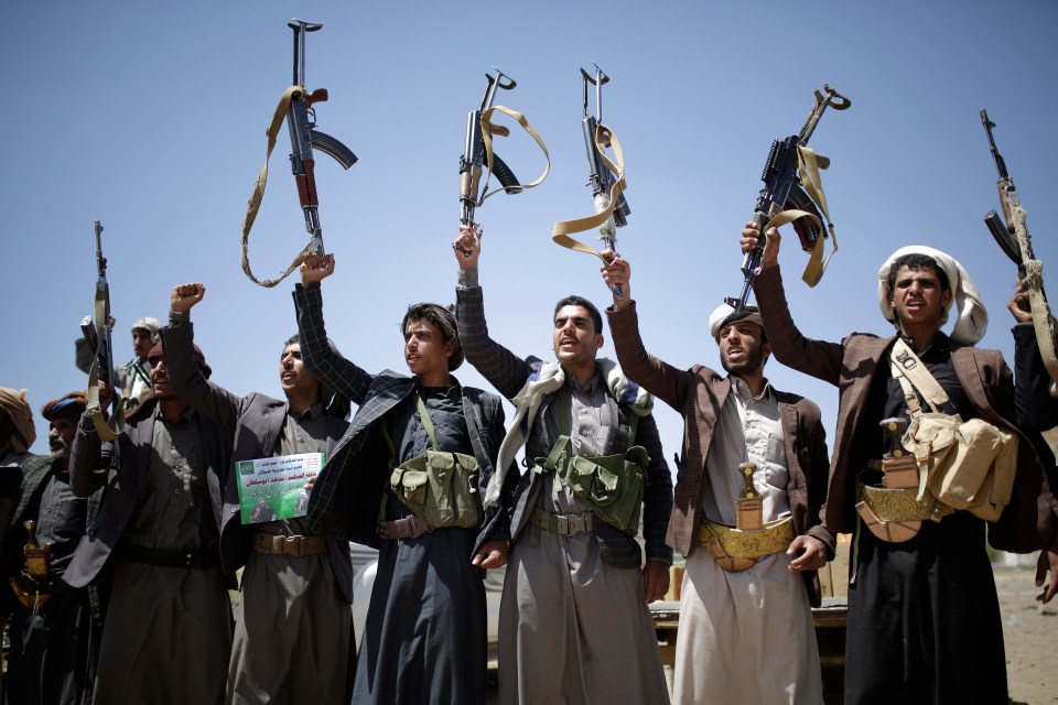  Houthi tribesmen hold their guns in the air during a tribal gathering