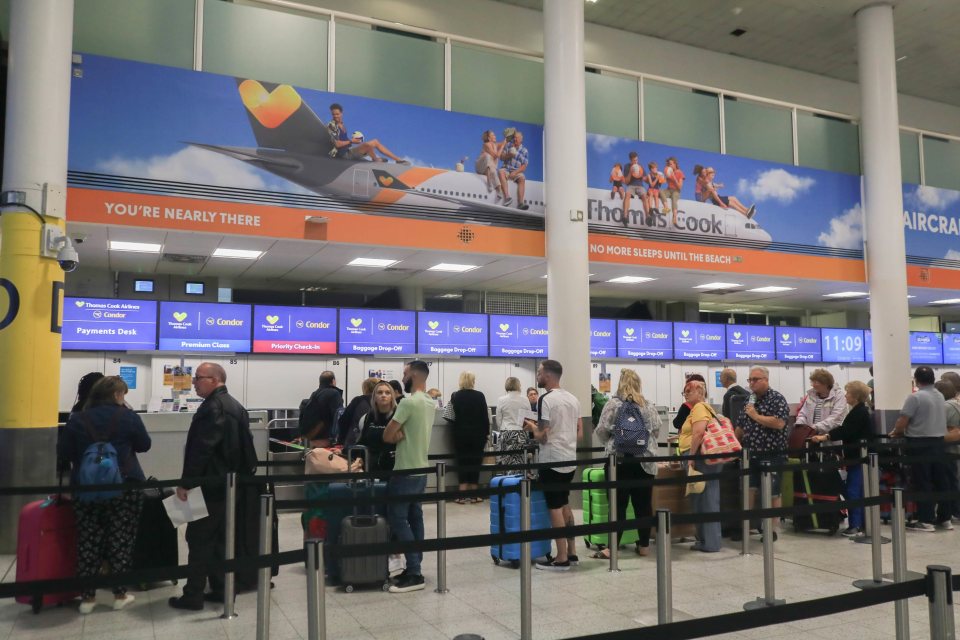 Passengers arrive at Thomas Cooks check-in counter at Gatwick Airport as the tour operator faces collapse