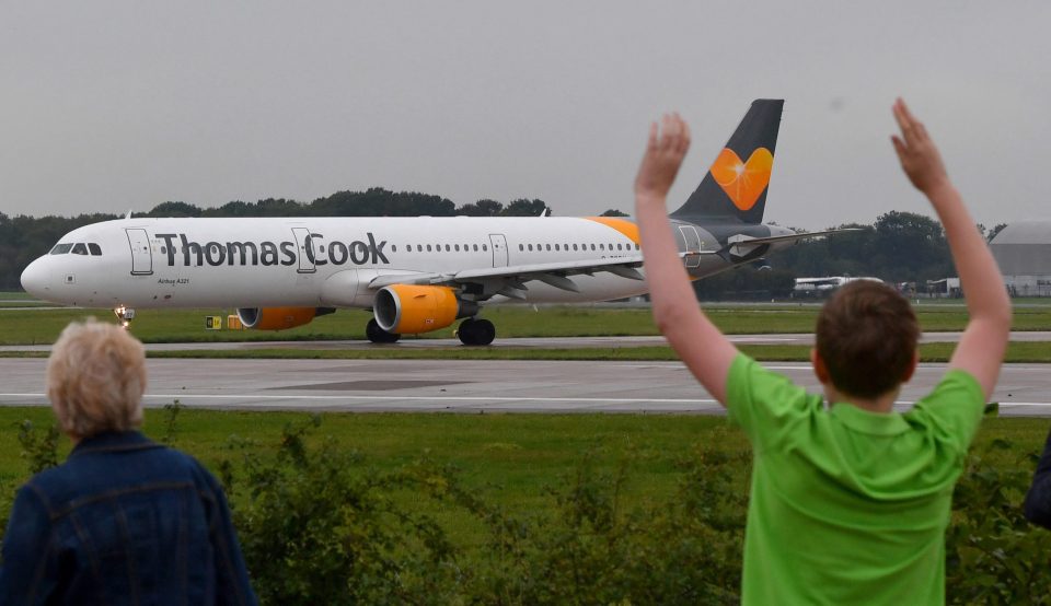 Pilots family members wave as a Thomas Cook flight departs Manchester Airport