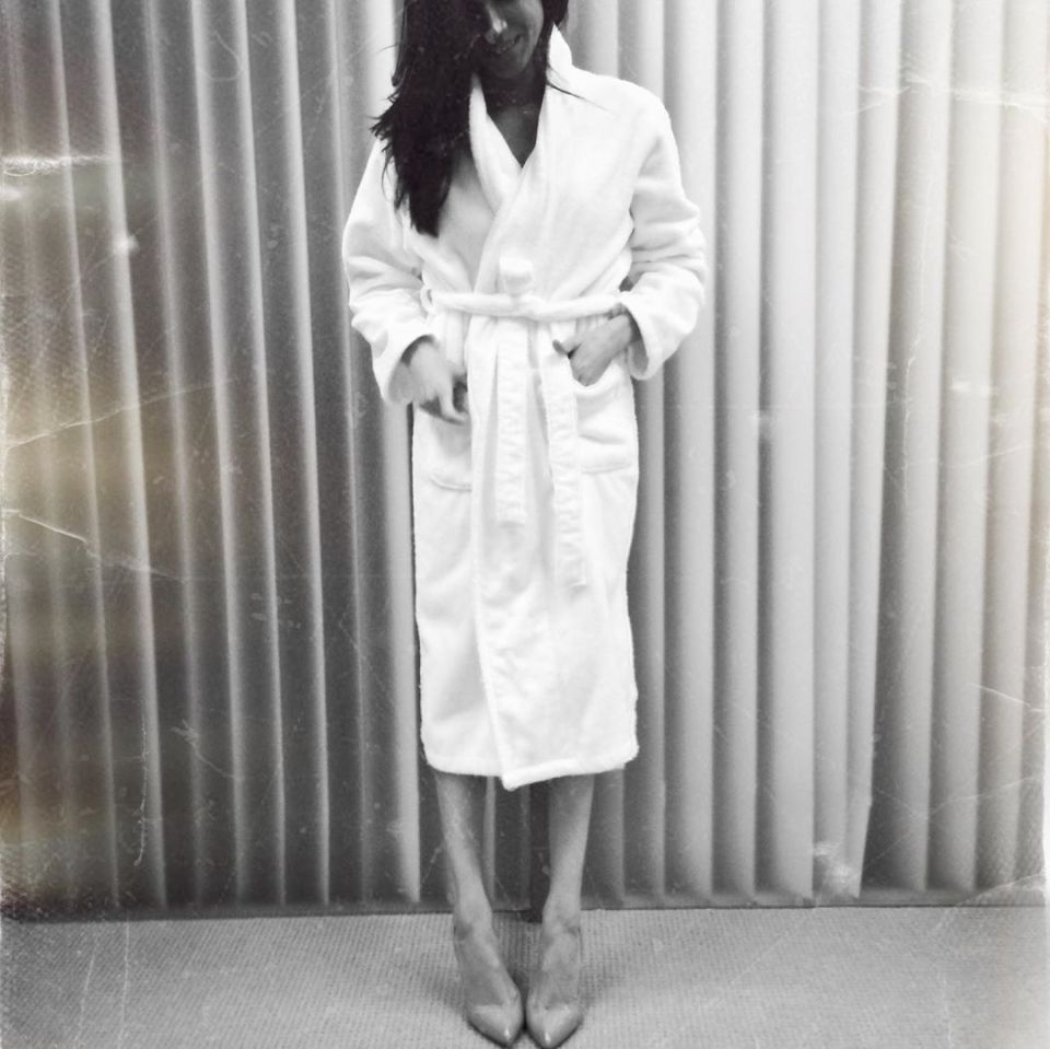  Another image saw Meghan posing in a dressing gown and stilettos