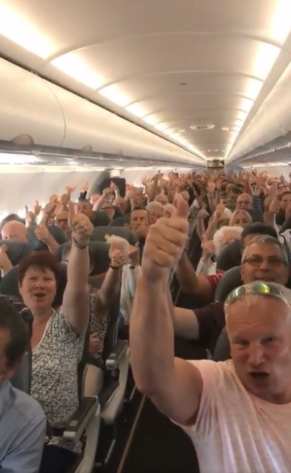 Passengers on board one of the last Thomas Cook flights give a thumbs up