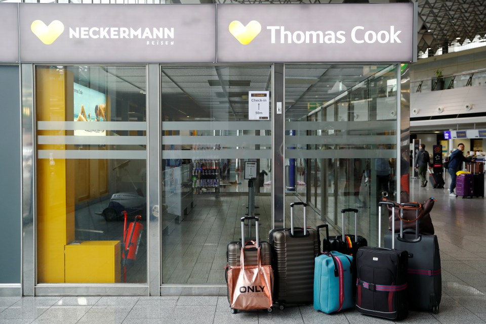 Suitcases are pictured next to a closed Thomas Cook counter at Frankfurt Airport