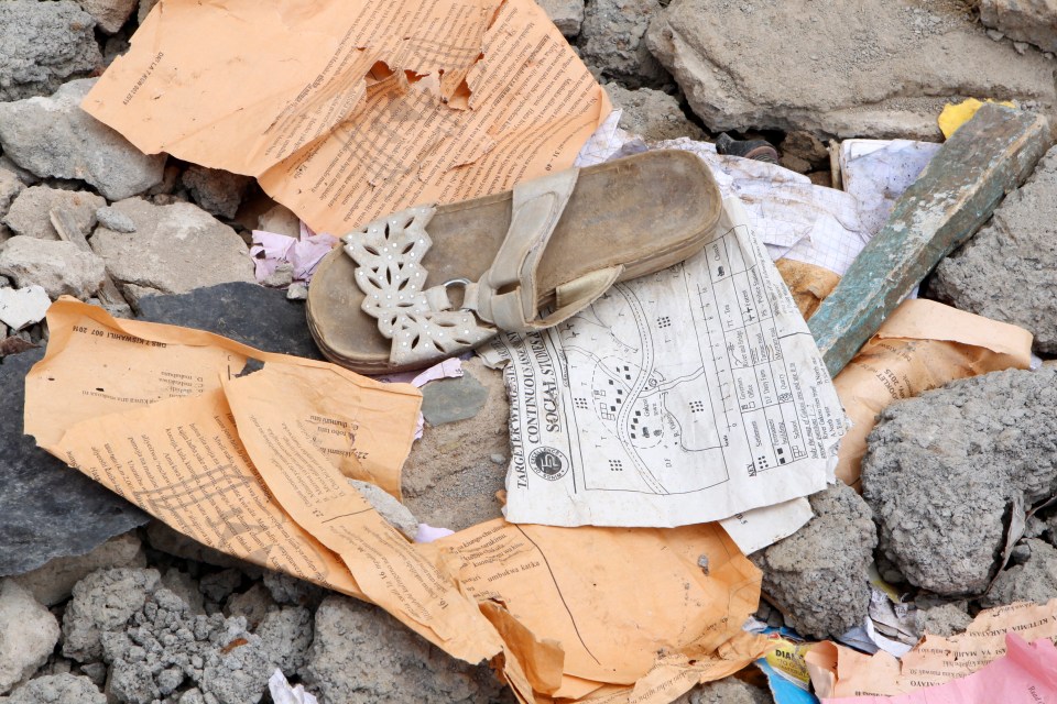  A sandal and worksheets are seen in the debris