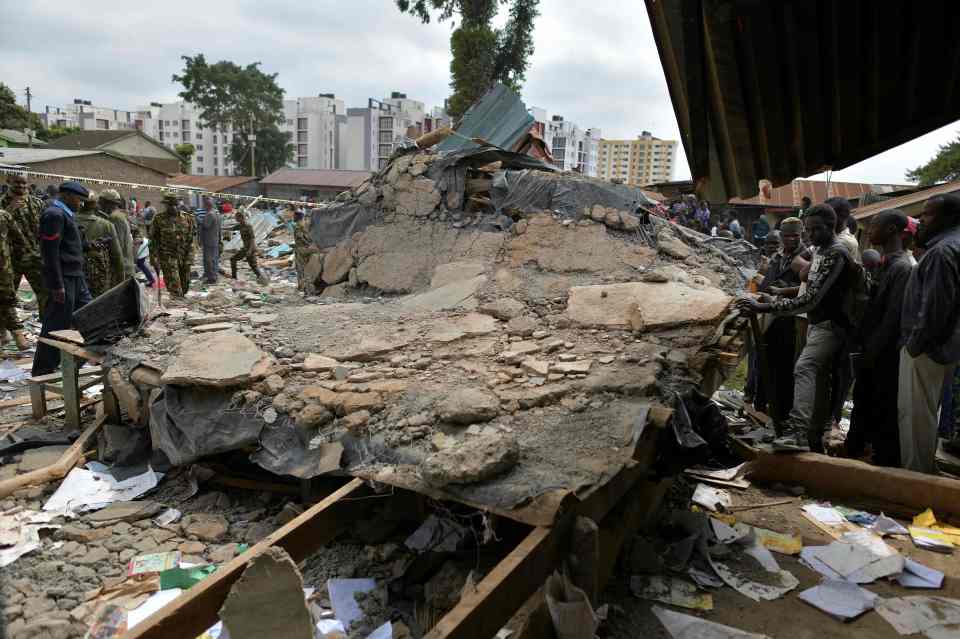  A large chunk of collapsed debris lies on the ground where a classroom block collapsed