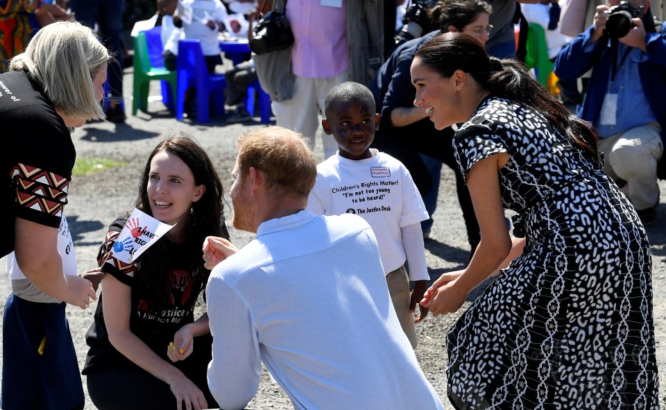 The duchess wore a patterned dress and had pulled her hair back in a sleek ponytail