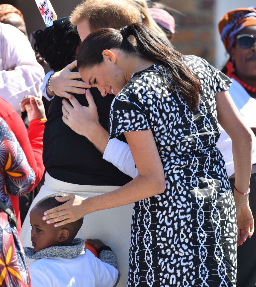  Meghan sweetly caresses child's head