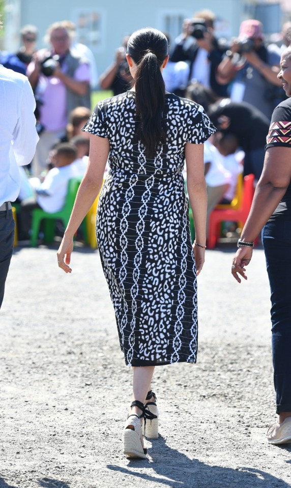 Meghan’s wrap dress features short capped sleeves and is ethically made