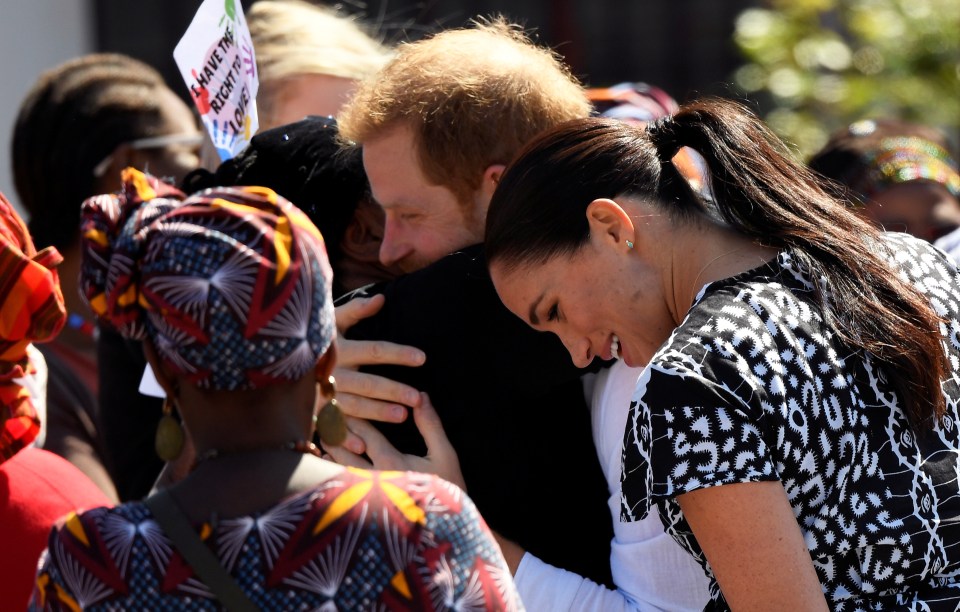  Harry gives a warm embrace to a resident of the township