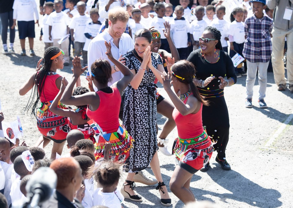 Meghan and Prince Harry took part in the dance during a visit to a local township on Monday