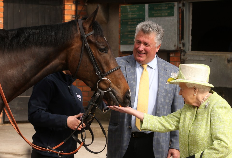 The Queen feeds a horse