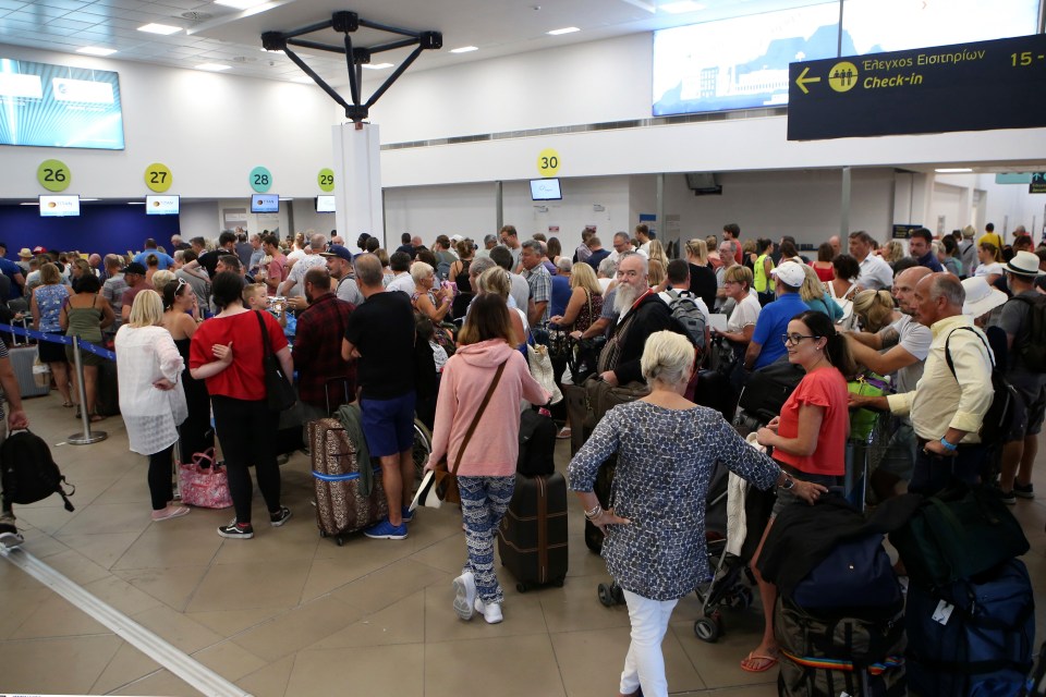 British tourists wait in a queue at the Ioannis Kapodistrias Airport in Corfu island