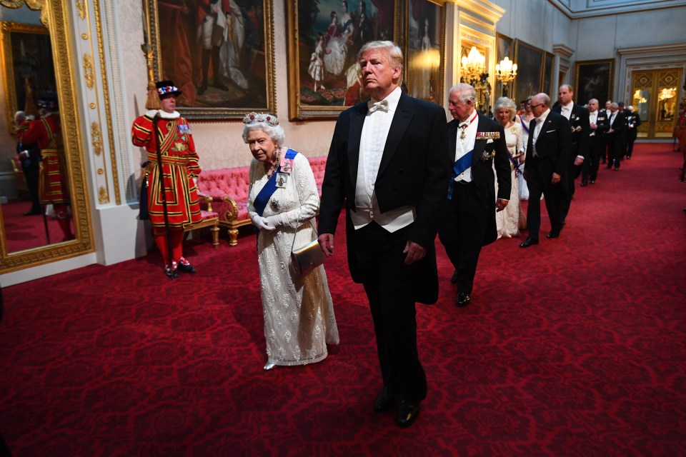 The Queen walks alongside President Trump at the State Banquet