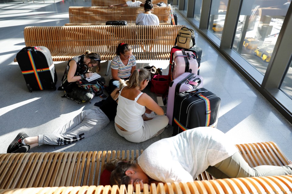 Karen Hendley, right back, from Hastings, wait on the floor at Dalaman Airport with her daughters and sister