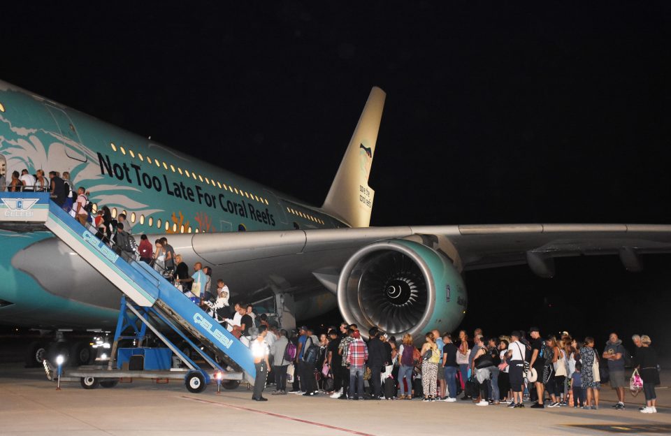  Thomas Cook holidaymakers in Turkey's Mugla board a plane at Dalaman Airport in Mugla